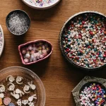 Bowls of colorful beads on a wooden table