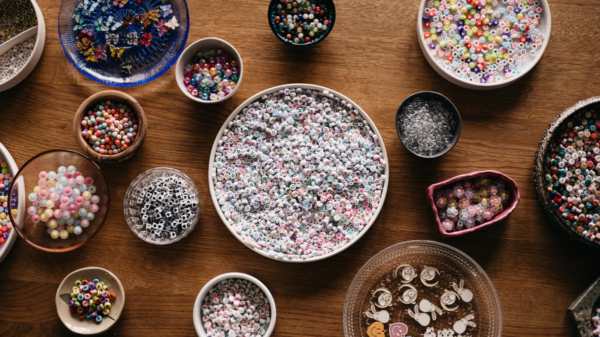 Many bowls filled with assorted beads