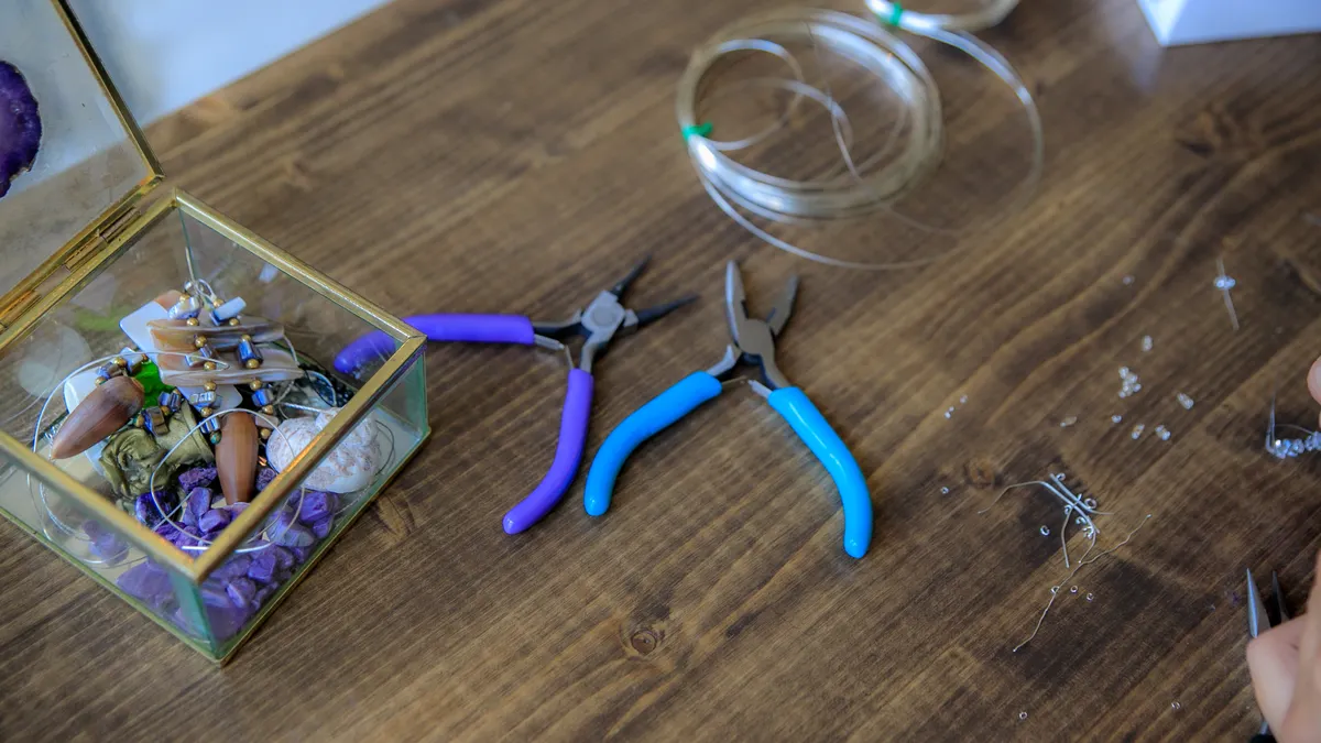 Bead tools and wire coils on a wood table