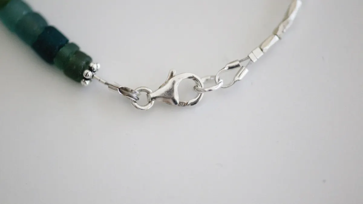 Beaded bracelet with silver clasp and crimped finish