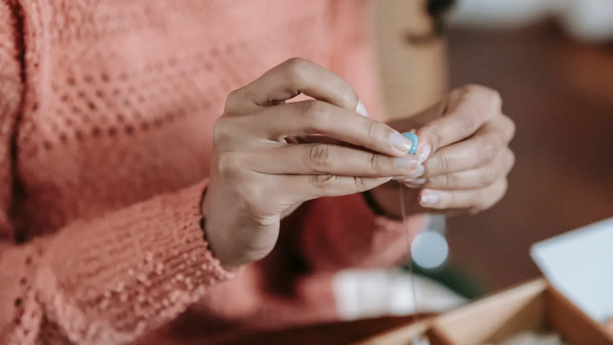 Hands fastening a small beaded bracelet